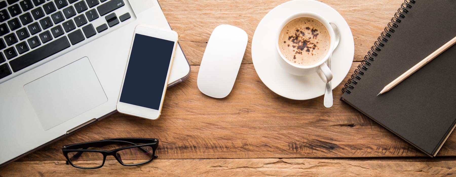 desk area with a smart device, a mug and some decor