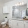 bathroom with a large mirror and walk-in shower